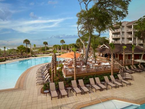 una piscina in un resort con sedie e tavoli di Omni Hilton Head Oceanfront Resort a Hilton Head Island