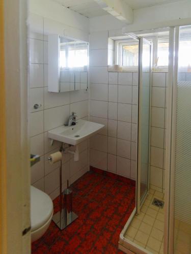a bathroom with a sink and a toilet at Myvo The House Geiteyjarströnd 4 in Geiteyjarstrond