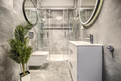 a bathroom with a shower and a toilet and a sink at AboutArtApartments - Otyńska 4 in Wrocław