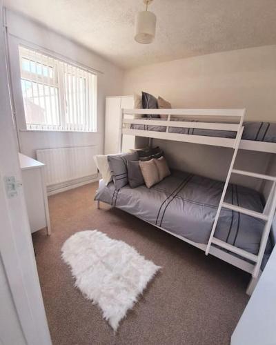 a bedroom with a bunk bed and a couch at Seaview Self Catering-Fleetview in Weymouth