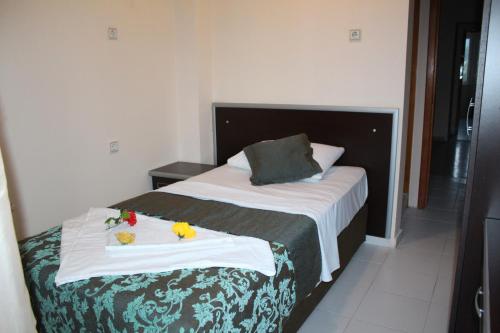 a hotel room with a bed with towels on it at Hotel Gold Stone in Beldibi