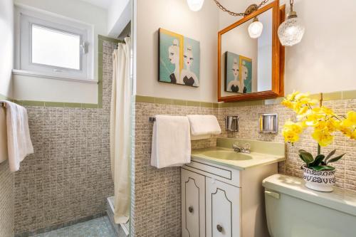 a bathroom with a sink and a toilet and a mirror at Vihome3001C1-3-Bedroom house facing park and school in Toronto