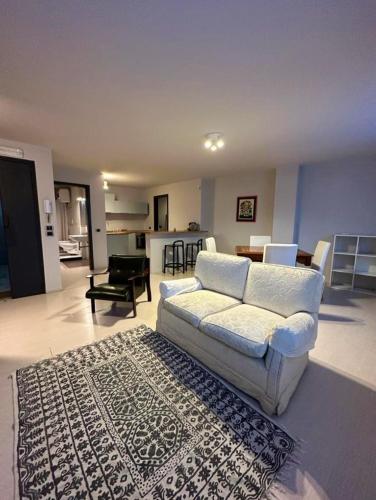a living room with a white couch and a rug at Casetta in Andria