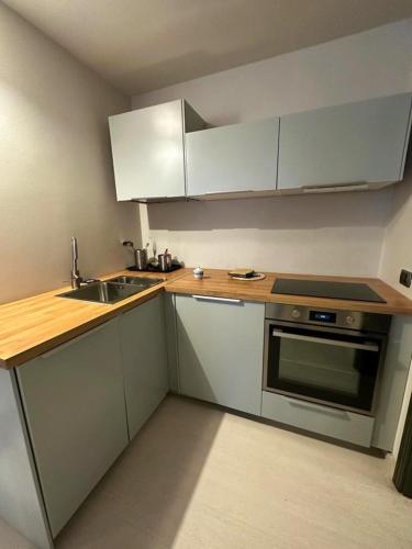 a small kitchen with white cabinets and a sink at Casetta in Andria