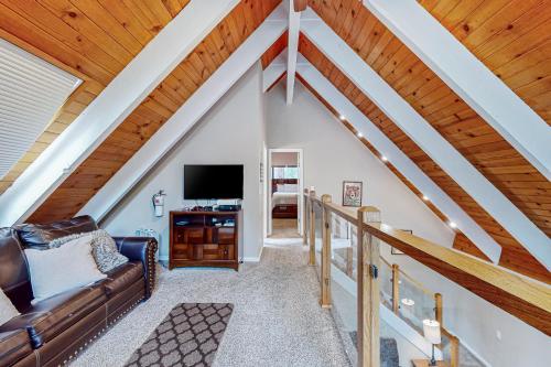 a living room with a couch and a tv at Montgomery Estates Retreat in South Lake Tahoe
