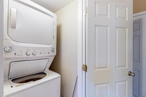 a washer and dryer in a bathroom with a door at Montgomery Estates Retreat in South Lake Tahoe