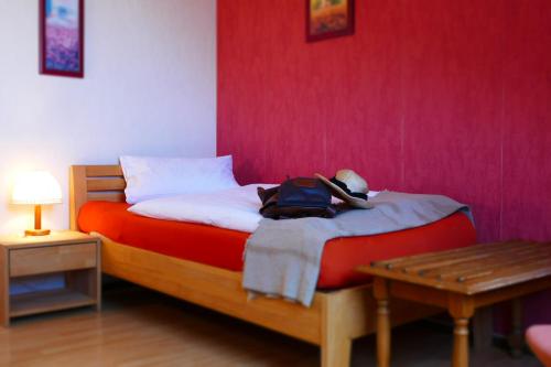 a bedroom with a bed with a backpack on it at Zenner's Landhotel in Newel