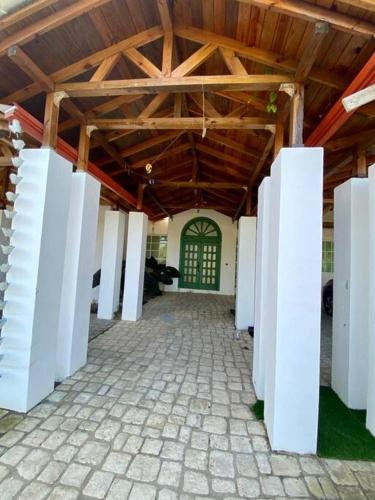 a large room with white columns in a building at Villa Rosa: Modern Colonial Home with Pool in Juan Dolio