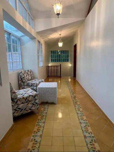 a living room with a couch and a table at Villa Rosa: Modern Colonial Home with Pool in Juan Dolio