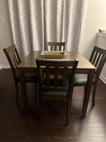 a wooden table with two chairs and a bowl on top at House of Peace - Includes Wi-Fi, Netflix in Ottawa
