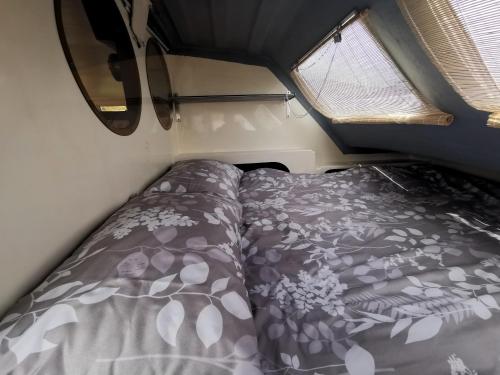 un lit dans une petite pièce avec une fenêtre dans l'établissement Nuit insolite - Bateau Logement Catamaran AVENTURE - Dormez sur l'eau, à Agay