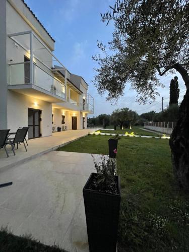 a large house with a patio and a yard at Villa Rodelia in Roda