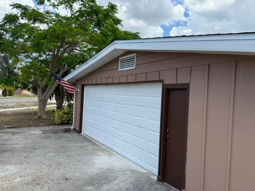 a garage with an american flag on top of it at Pool house by the harbor in Port Charlotte