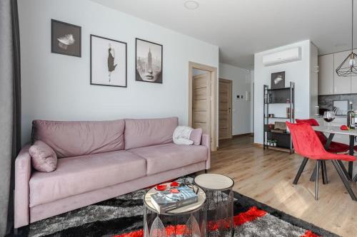 a living room with a couch and a table at Home sweet home, cozy apartments, free underground parking, long stays welcome in Vilnius