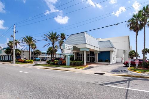 a mobil gas station on a street with palm trees at SeaBliss, oceanfront 1st floor cozy condo in Daytona Beach