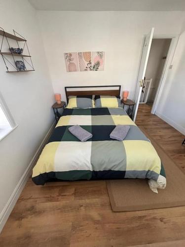 a bedroom with a bed with pillows on it at Cute 1 bed flat in Southwold in Southwold