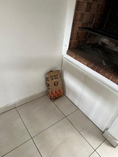 a box sitting on the floor next to a wall at Mar y Asados - Chalet hasta 19 huéspedes con dos Parrillas in Mar del Plata