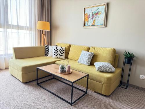 a living room with a couch and a coffee table at City view in Residences in Burgas