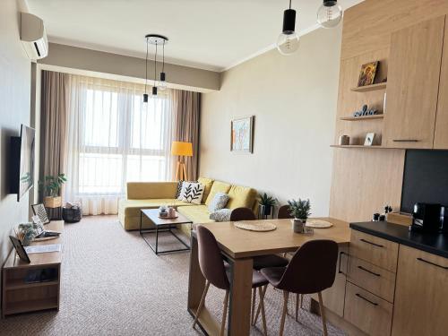 a living room with a couch and a table at City view in Residences in Burgas City