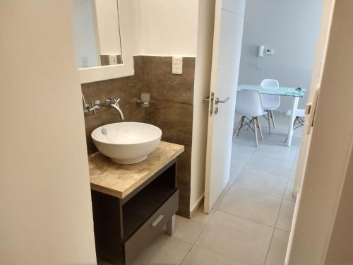 a bathroom with a bowl sink on a counter at Zona residencial frente al lago! in Villa Carlos Paz