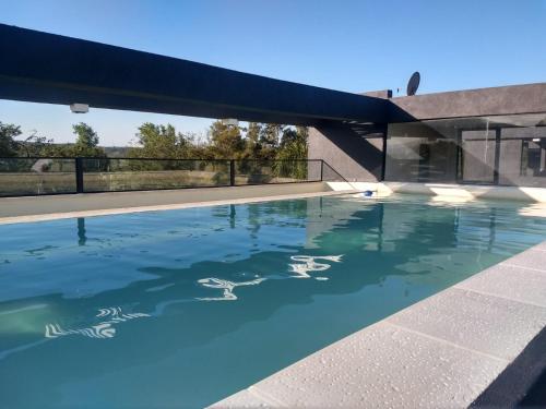 a swimming pool with ducks in the water at Zona residencial frente al lago! in Villa Carlos Paz