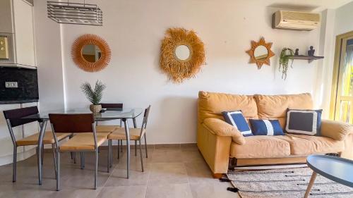 a living room with a couch and a table at OleHolidays 903 Romana Playa junto al mar in Marbella