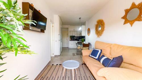 a living room with a couch and a table at OleHolidays 903 Romana Playa junto al mar in Marbella