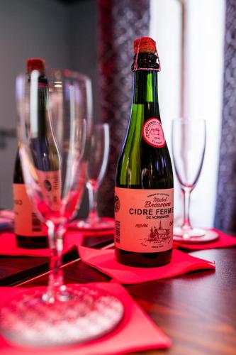 une bouteille de vin posée sur une table avec des verres dans l'établissement Loveroom sauna, balnéo, parking privé dans le centre de Honfleur, à Honfleur
