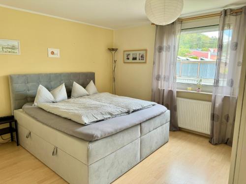 Schlafzimmer mit einem großen Bett und einem Fenster in der Unterkunft Ferienwohnung Bille in Pirna