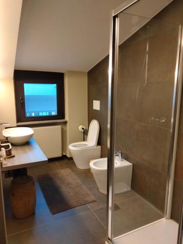 a bathroom with a shower and a toilet and a sink at Rota's House III in Bergamo