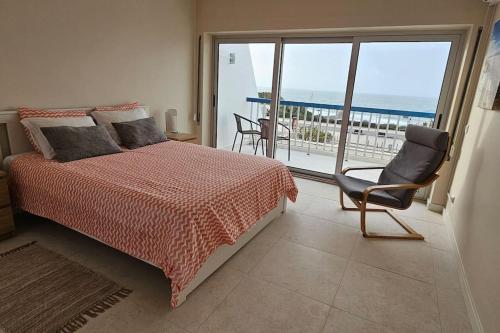 een slaapkamer met een bed en uitzicht op de oceaan bij Rocha Dreamhouse 1 - Duplex Renovated 2024 in Portimão