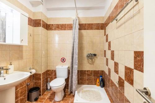 a bathroom with a toilet and a sink at Corfu Downtown in Corfu Town