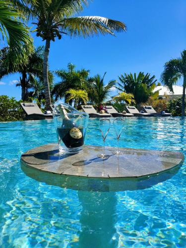 a table in the water in a swimming pool at Villa Diamantine - Infinity pool and Jacuzzi in Cul de Sac