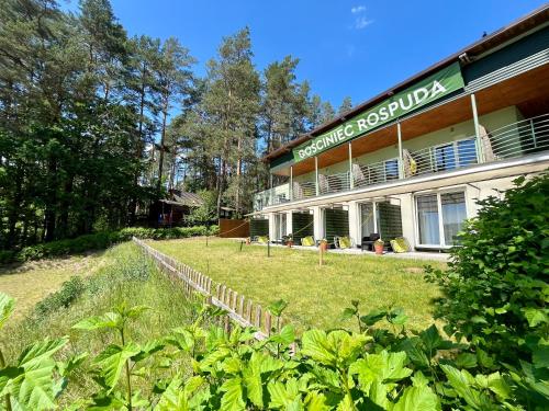 a building with a sign on the side of it at Gościniec Rospuda 2 in August&oacute;w