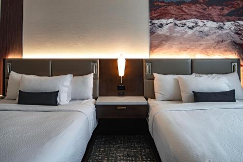 two beds sitting next to each other in a hotel room at Hotel 43 Boise in Boise