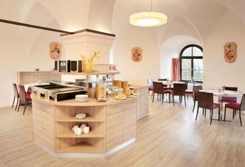 a kitchen and dining room with a table and chairs at Schatz.Kammer Burg Kreuzen in Bad Kreuzen