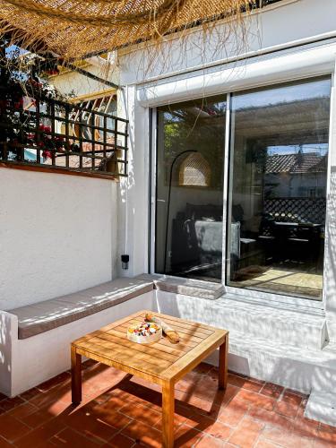 une table basse sur un patio avec une fenêtre dans l'établissement LA CASA SORRA, à Canet