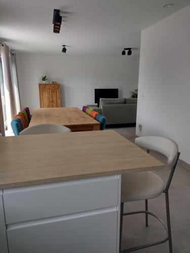 a living room with two tables and a couch at Nieuwe rijwoning met gezellig terras in Assenede