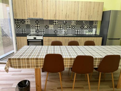 a kitchen with a table with chairs around it at Star Hostel in Piraeus