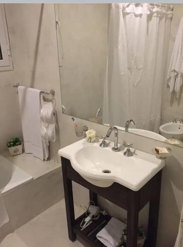 a bathroom with a sink and a tub and a mirror at Refugio Zen in Sierra de los Padres