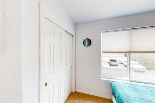 a white room with a window and a bed at Victorian Dream in Arroyo Grande