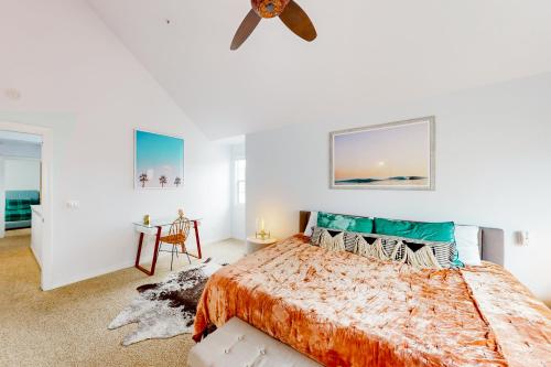 a bedroom with a bed and a ceiling fan at Victorian Dream in Arroyo Grande