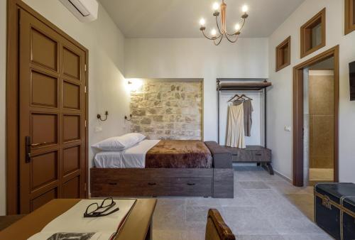 a bedroom with a bed and a brick wall at Spanish Knights Inn in Rhodes Town
