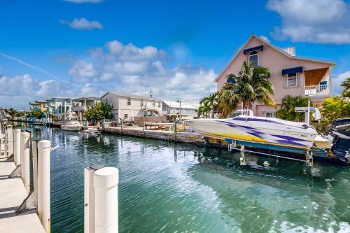 a boat is docked at a dock in a marina at Lime in the Coconut in Marathon