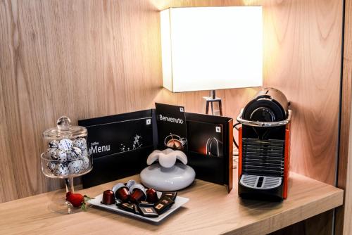 a table with a lamp and a box of chocolates at Sun Suite Luxury Pantheon in Rome