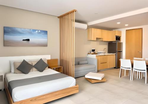 a hotel room with a bed and a kitchen at Levitat 32 in Playa del Carmen