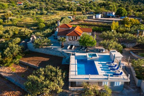 uma vista aérea de uma casa com piscina em VILLA AGAPE - Stone villa on 15k m2 olive grove - Incredible 360 view em Mirce