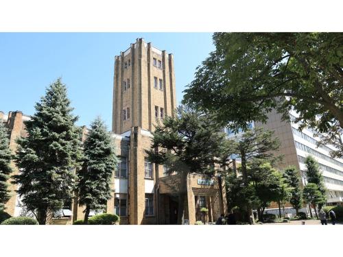 a tall brick building with trees in front of it at KITA HOTEL - Vacation STAY 69750v in Morioka