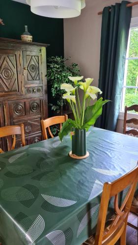 a table with a potted plant on top of it at LA TANIÈRE in Gueures