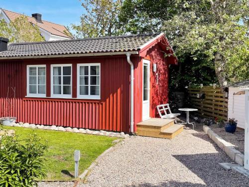 a red shed with a bench in a yard at 4 star holiday home in Öckerö-By Traum in Öckerö